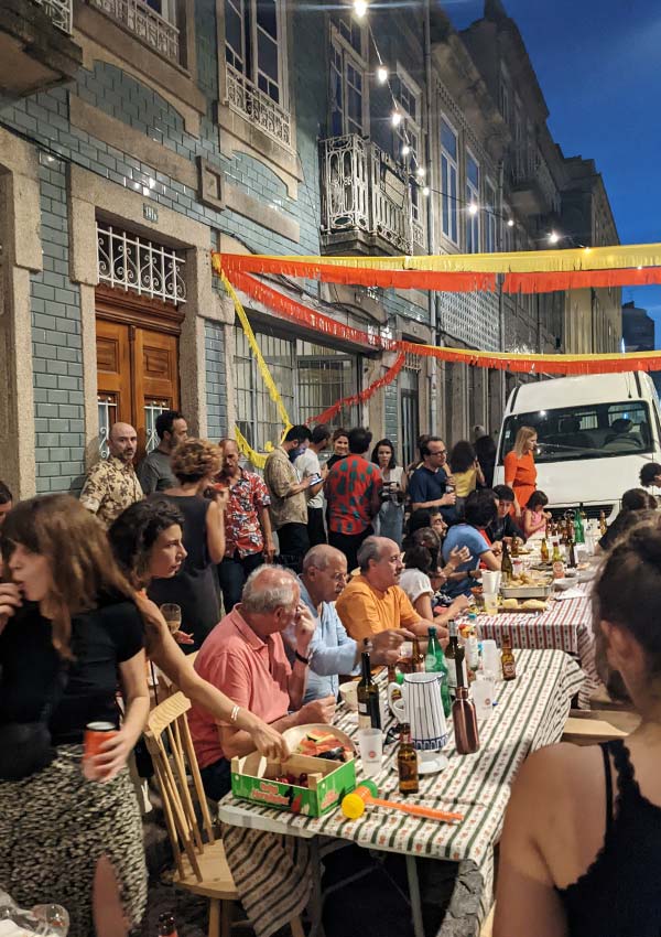 Porto during São João festivities - a family eats on the street