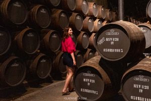 Daniela walking between barrels of aging port at Graham's in Vila Nova de Gaia Porto