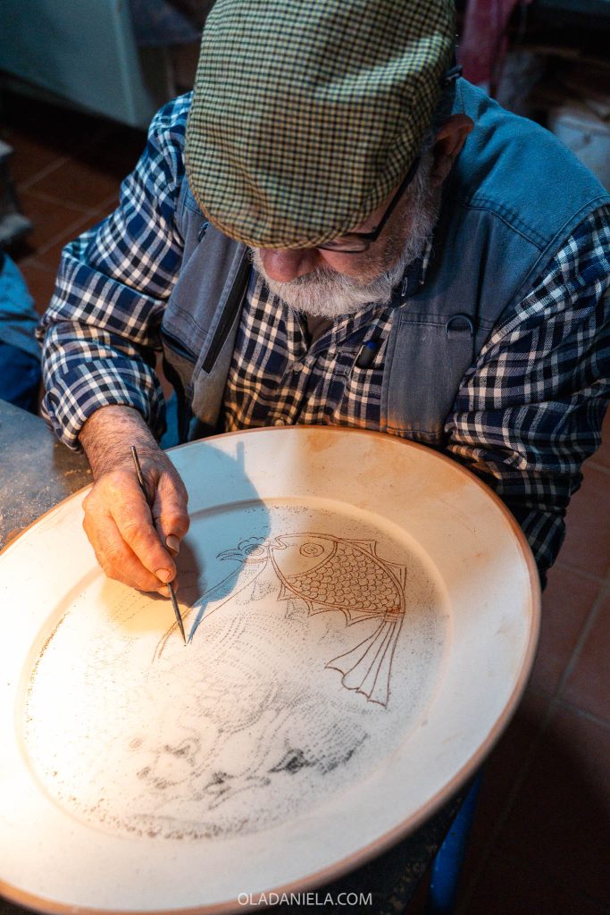 Master Xico Tarefa painting a terracotta plate at Olaria XT pottery workshop in Redondo, Alentejo