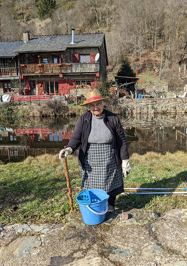 Rio de Onor is one of the most beautiful and most unique villages in Portugal. An old lady washing clothes in the river