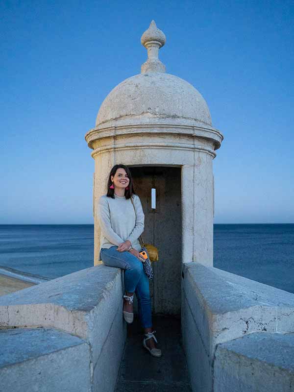 Daniela in Sesimbra sitting at the fort