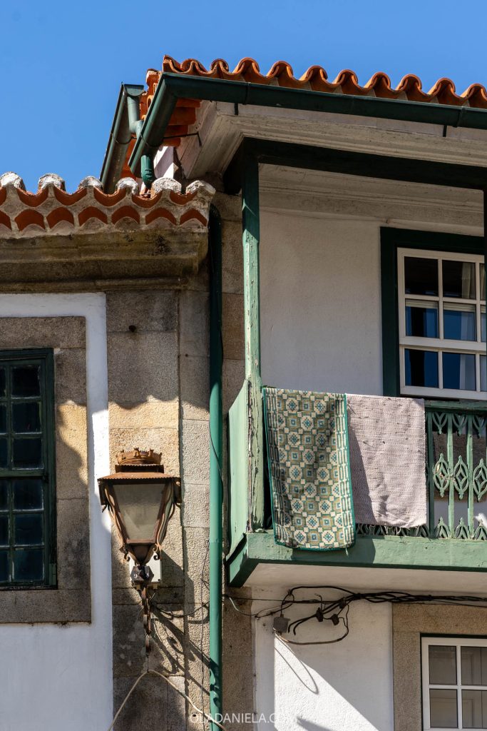 Blankets hanging on a balcony in Viseu, Portugal